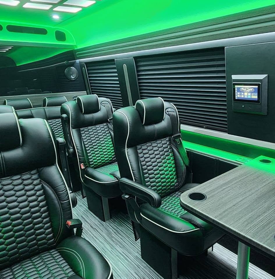 Executive Sprinter interior with leather seats and green party lighting